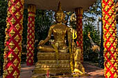 Vientiane, Laos - Pha That Luang, various Buddha statues among the Other structures on the ground. 